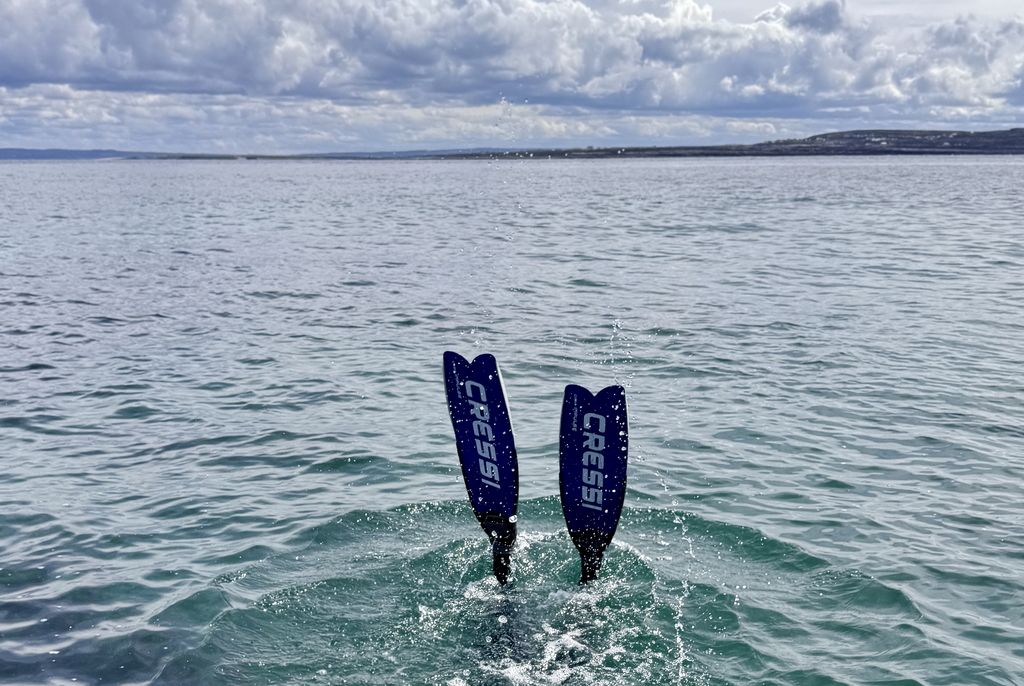 Freediver descends in clear Atlantic waters near Inishmore, Aran Island