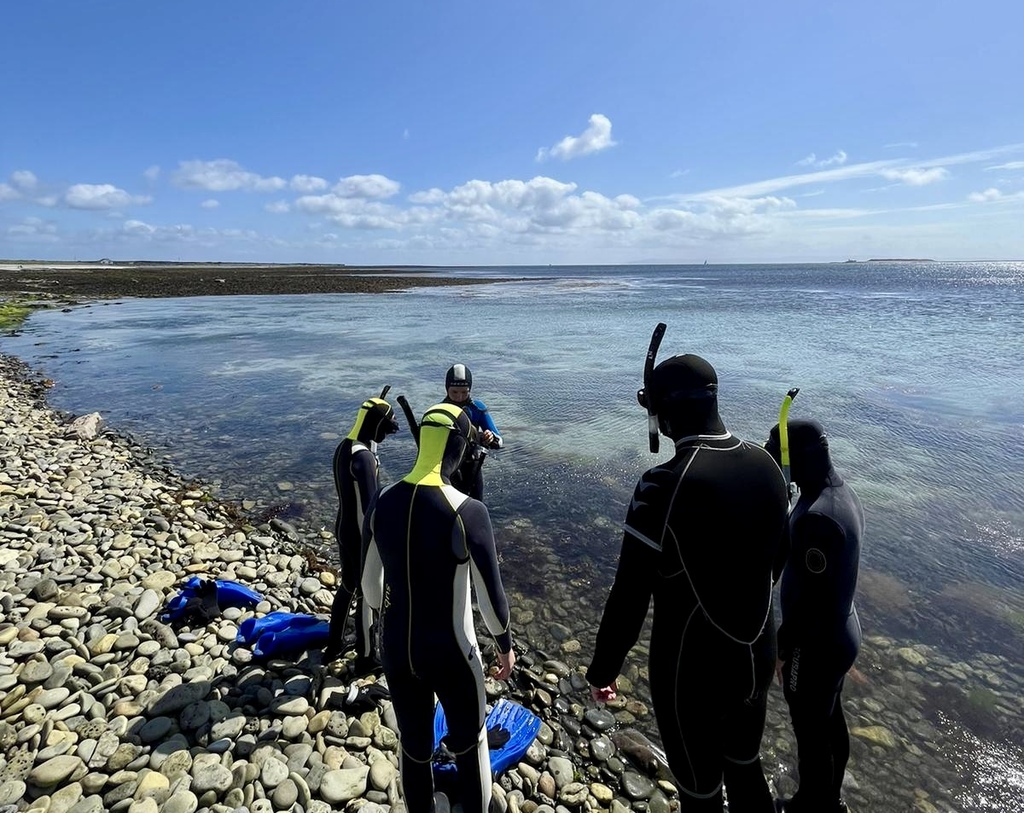 Snorkelers getting ready to explore clear Atlantic waters on Inishmore, Aran Islands