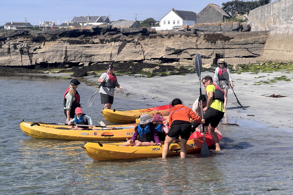 group of family preparing to explore inishmore coastline on kayaks