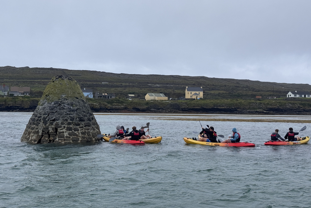 Group of kayakers enjoying paddling along Inishmore coastline