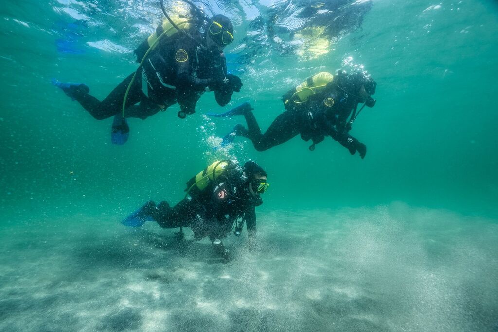Three scuba divers during their Try Dive experience